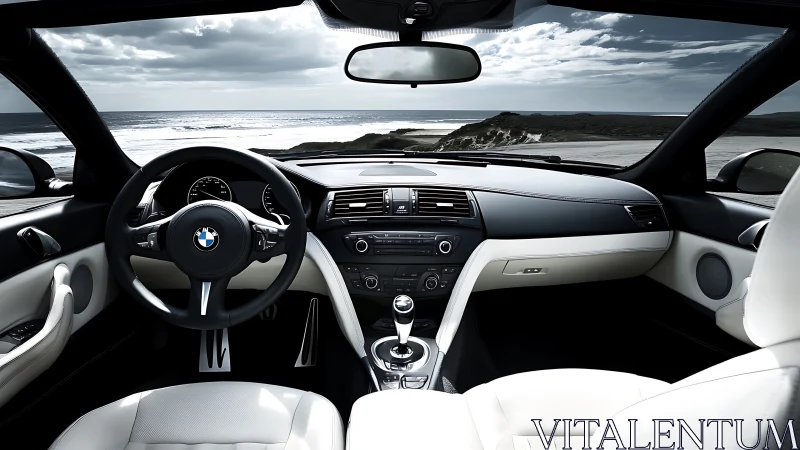 BMW car interior with ocean view through front windshield.
