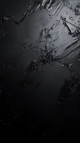 Dark textured surface shows angular ridges and glossy planes