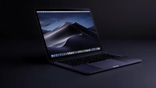 Midnight laptop glows with desert dunes on luminous screen.