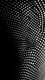 Monochrome curved grid of illuminated circular light points.