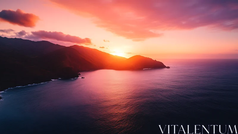 Coastal headland bathed in radiant magenta ocean sunset light.