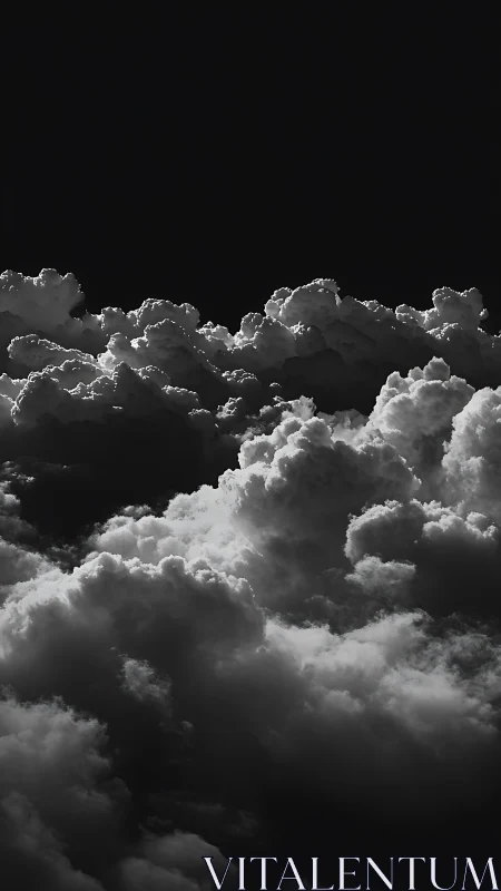 Stormlit cumulus clouds glow against deep black sky.