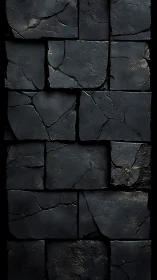 Weathered charcoal stone wall with quiet fractured rhythm.