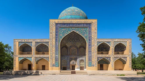 Islamic madrasa facade with blue tiled dome under clear sky