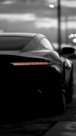 Sleek sports car rear view in dramatic low light scene.