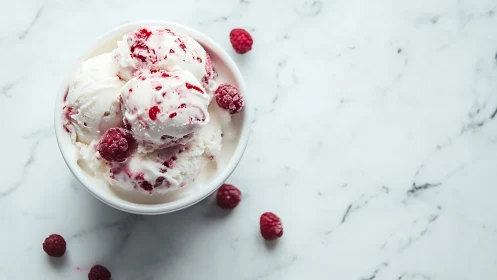 Raspberry swirl ice cream scoops on cool marble tabletop.