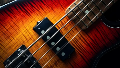 Close-up of electric bass guitar strings and sunburst body.