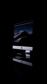 Isolated aluminum desktop workstation with nocturnal display.