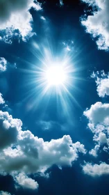 Radiant midday sun bursts through vivid blue clouded sky.