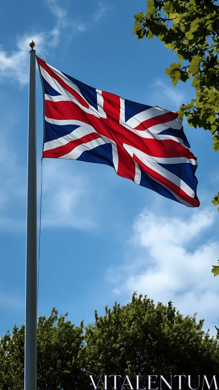 Union Jack unfurls proudly above sunlit summer treetops.