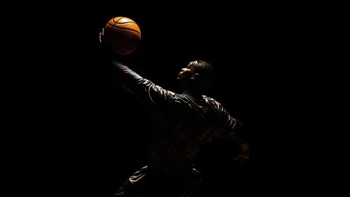 High-contrast low-key photograph of basketball jump reach.