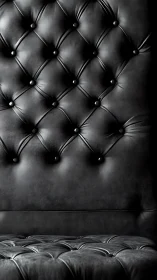Plush black leather tufting inviting quiet, cozy moments.