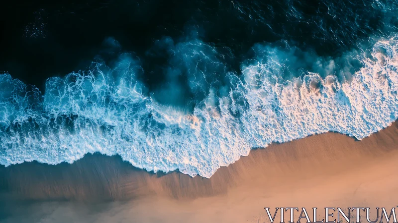 Foaming ocean waves roll onto a tranquil golden shoreline.
