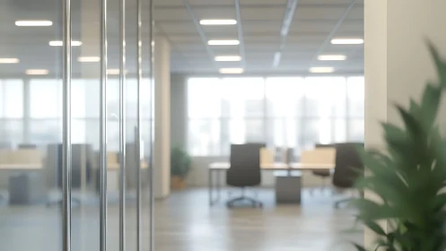 Glass office partition and open-plan workspace in soft focus
