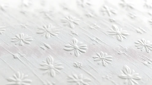 Soft white floral embossing with gentle textured details.