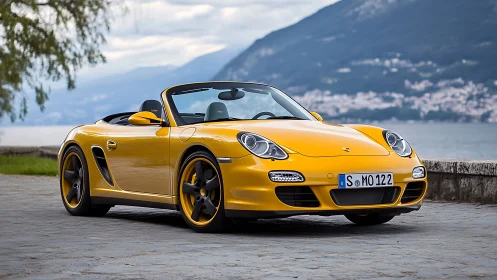 Sunlit yellow roadster resting by a glassy lakeside promenade.