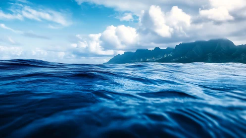 Gentle ocean swells welcoming distant misty island peaks.