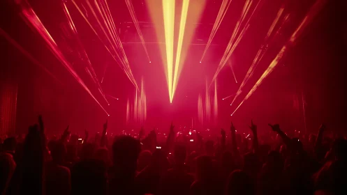 Red-saturated concert scene uses converging yellow beams and dense haze