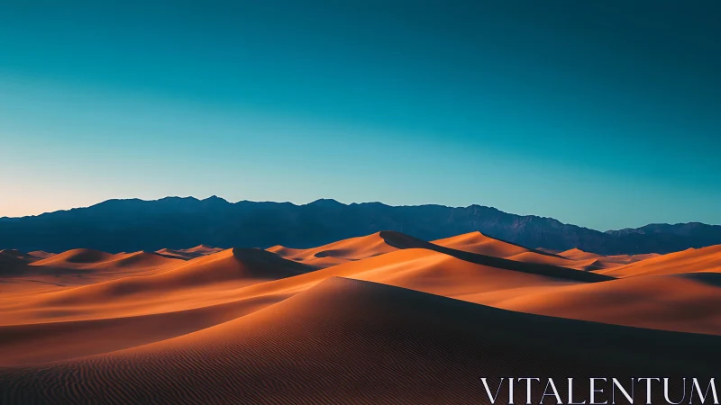 Sunlit desert dunes roll beneath a deep blue twilight sky.