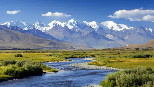 Snowcapped mountain range above winding alpine river valley.