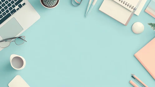 Organized desktop layout with laptop and stationery on blue.