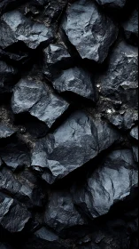 Close-up view of dark angular rock formations in layers.