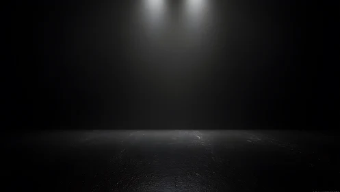 Minimalist dark studio stage with dual overhead spotlights.