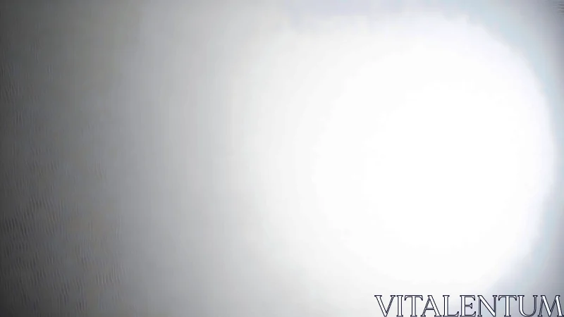 Circular overexposed light source on neutral gray surface.