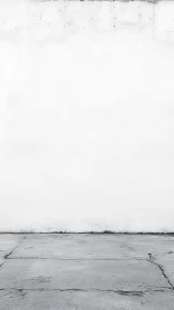 Minimalist white concrete wall with cracked floor plane.