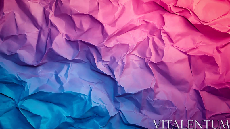 Crumpled gradient paper glows in soft pink and blue light