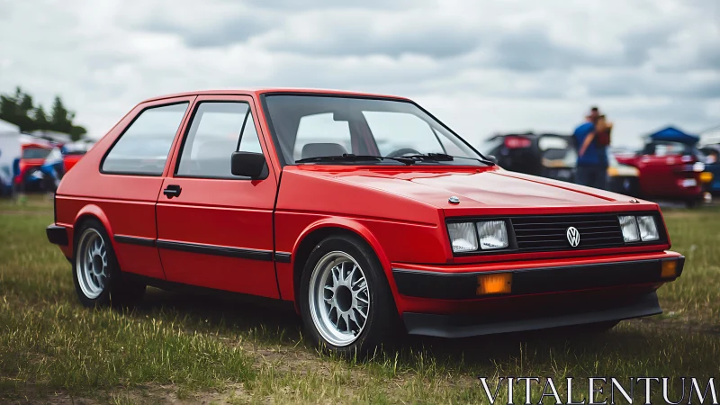 Lowered red VW hatchback with period-correct wheels on grass field