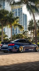 Lowered BMW coupe under palm trees in coastal cityscape.