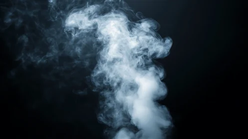 Soft white smoke swirling gently through midnight air.
