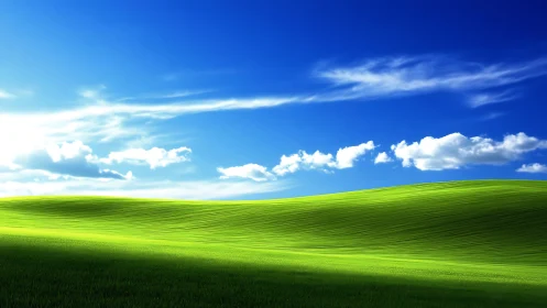 Vivid green hills roll beneath a deep serene summer sky