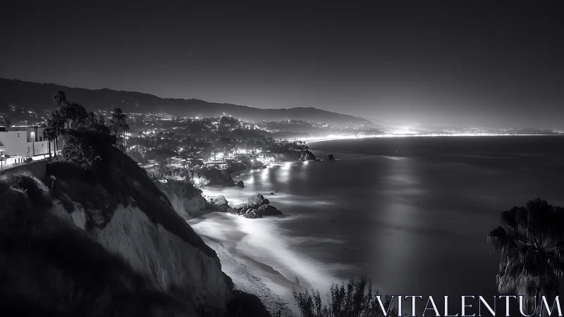 Long-exposure monochrome coastal cityscape with illuminated shoreline