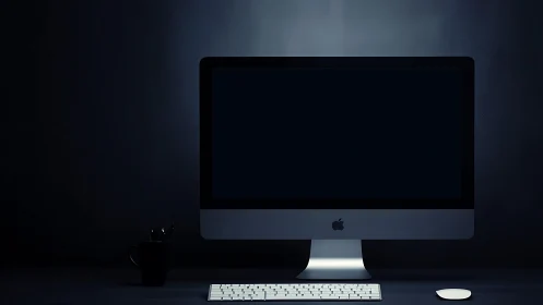 Minimal desktop workstation in low key studio lighting.