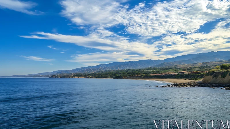 Coastal headland, ocean surface, and distant mountain range