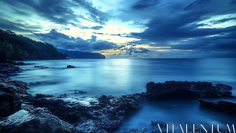 Long-exposure twilight seascape reveals cobalt-toned coastal stillness