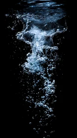 Water splash and bubbles captured underwater on black.