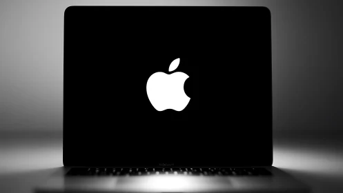 Minimalist laptop screen glows with bold white apple logo