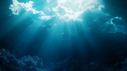 Subsurface seascape with sunlight beams and cloud cover.