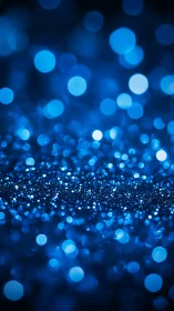 Blue bokeh glitter field with luminous defocused lights.