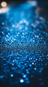 Defocused blue bokeh lights shimmer across dark surface