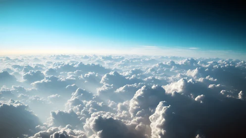 Endless sunlit cloudscape under luminous blue horizon.