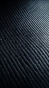 Dark metallic wave pattern in closeup abstract texture.