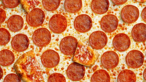 Golden pepperoni slices cover cozy cheesy pizza surface