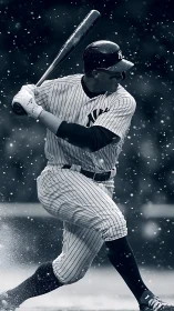 Baseball batter swings through snowfall under stadium lights