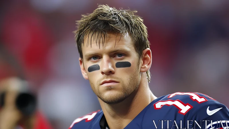 Focused football player stands ready in bold navy uniform