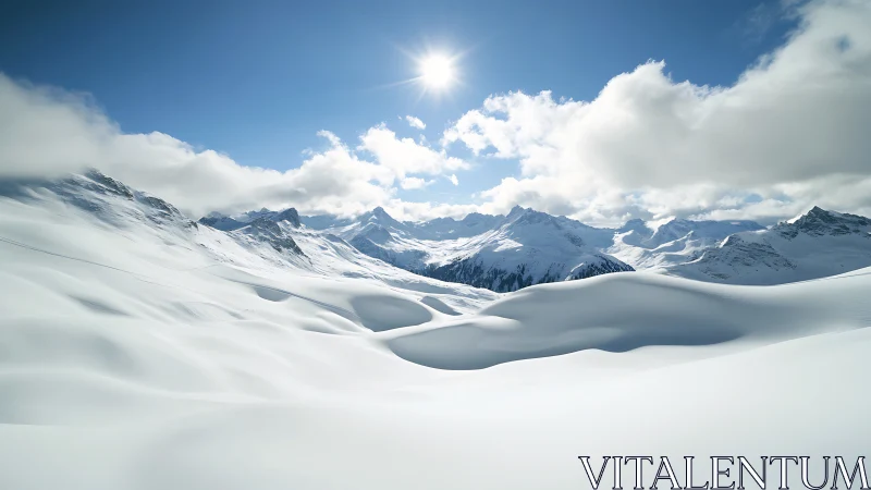 Sunlit snow dunes cradled by quiet winter mountains.