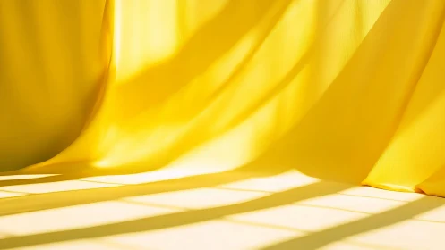 Yellow fabric curtain catches strong geometric sunlight.
